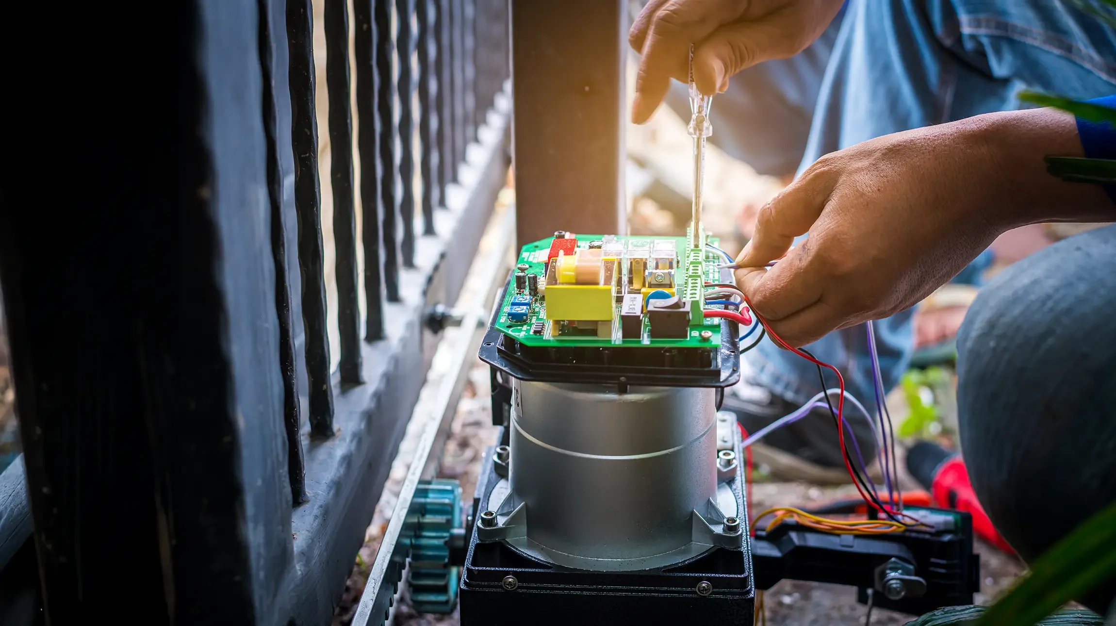 Mécanicien automobile travaillant sous le capot ouvert d'une voiture blanche dans un garage professionnel